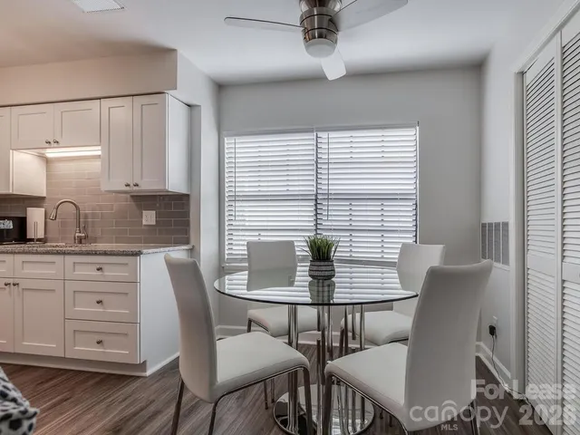 a living room with furniture a window and a flat screen tv