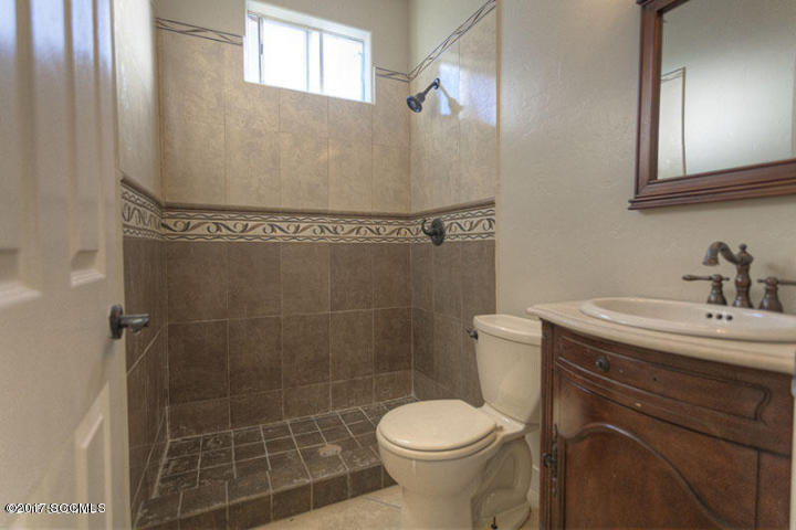 430 Churea Lane Rio Rico, AZ 85648 - Photo 11 of 14 a bathroom with a sink a toilet and shower