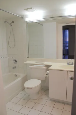 a bathroom with a toilet sink and shower
