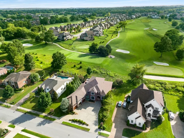 an aerial view of residential houses with outdoor space and river view
