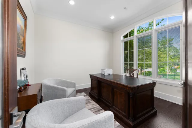 a dining room with furniture and a large window