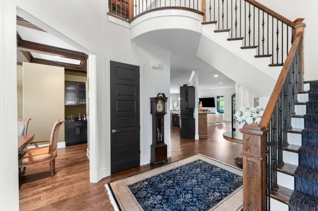 a view of entryway and hall with wooden floor