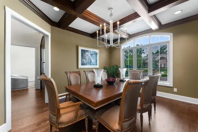 a view of a dining room with furniture wooden floor and chandelier