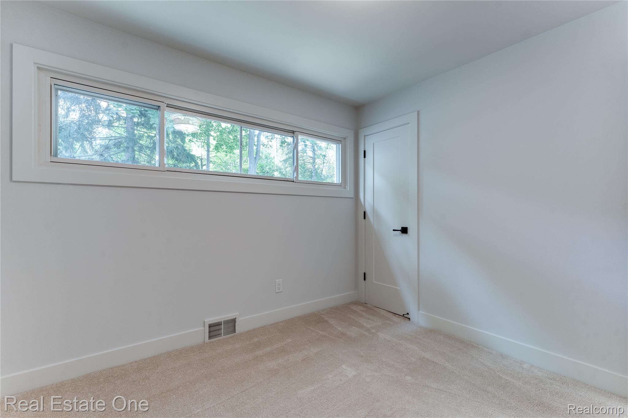 786 South Cranbrook Road Bloomfield Hills, MI 48301 - Photo 21 of 38 Carpeted spare room featuring baseboards