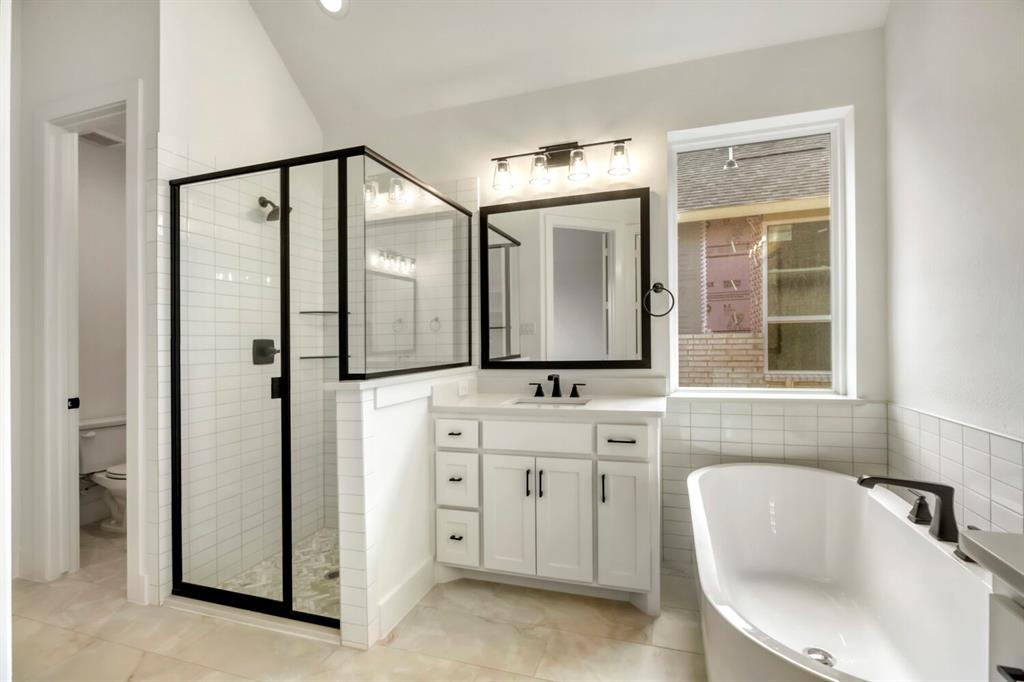 4312 Double Diamond Prosper, TX 75078 - Photo 16 of 29 a bathroom with a bathtub sink and mirror