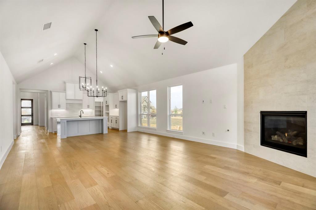 4312 Double Diamond Prosper, TX 75078 - Photo 6 of 29 a view of an empty room with a fireplace and a window