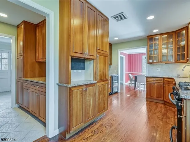 a living room with furniture a dining table and wooden floor