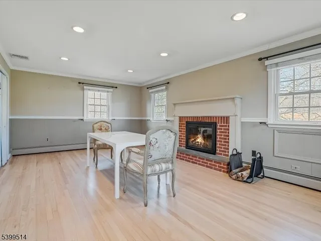 a view of a chair and table in backyard of the house