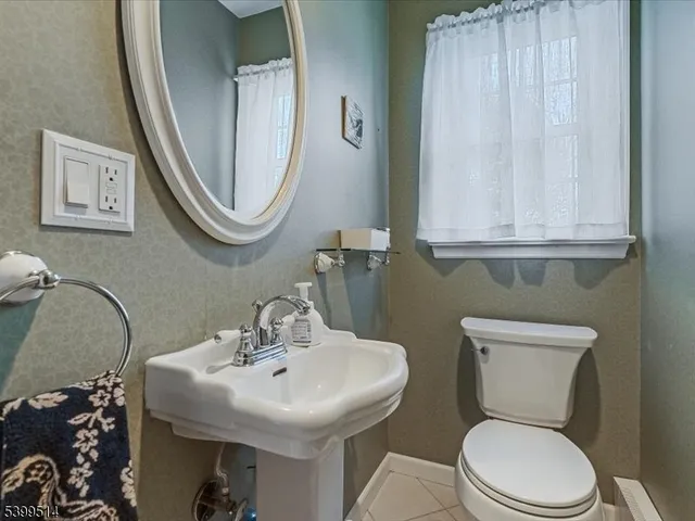 a view of a refrigerator in kitchen and wooden floor