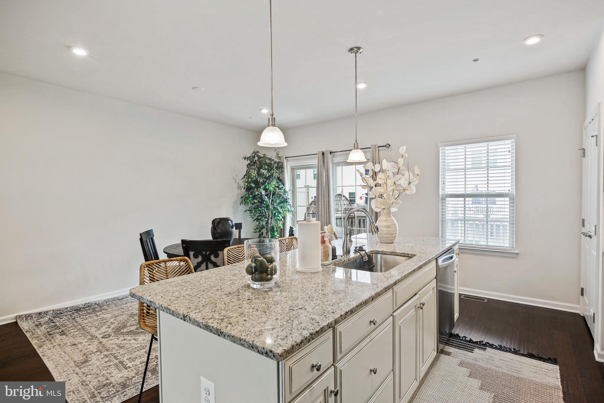 10012 Sandy Run Road Baltimore, MD 21220 - Photo 19 of 34 a kitchen with granite countertop a sink a center island and windows