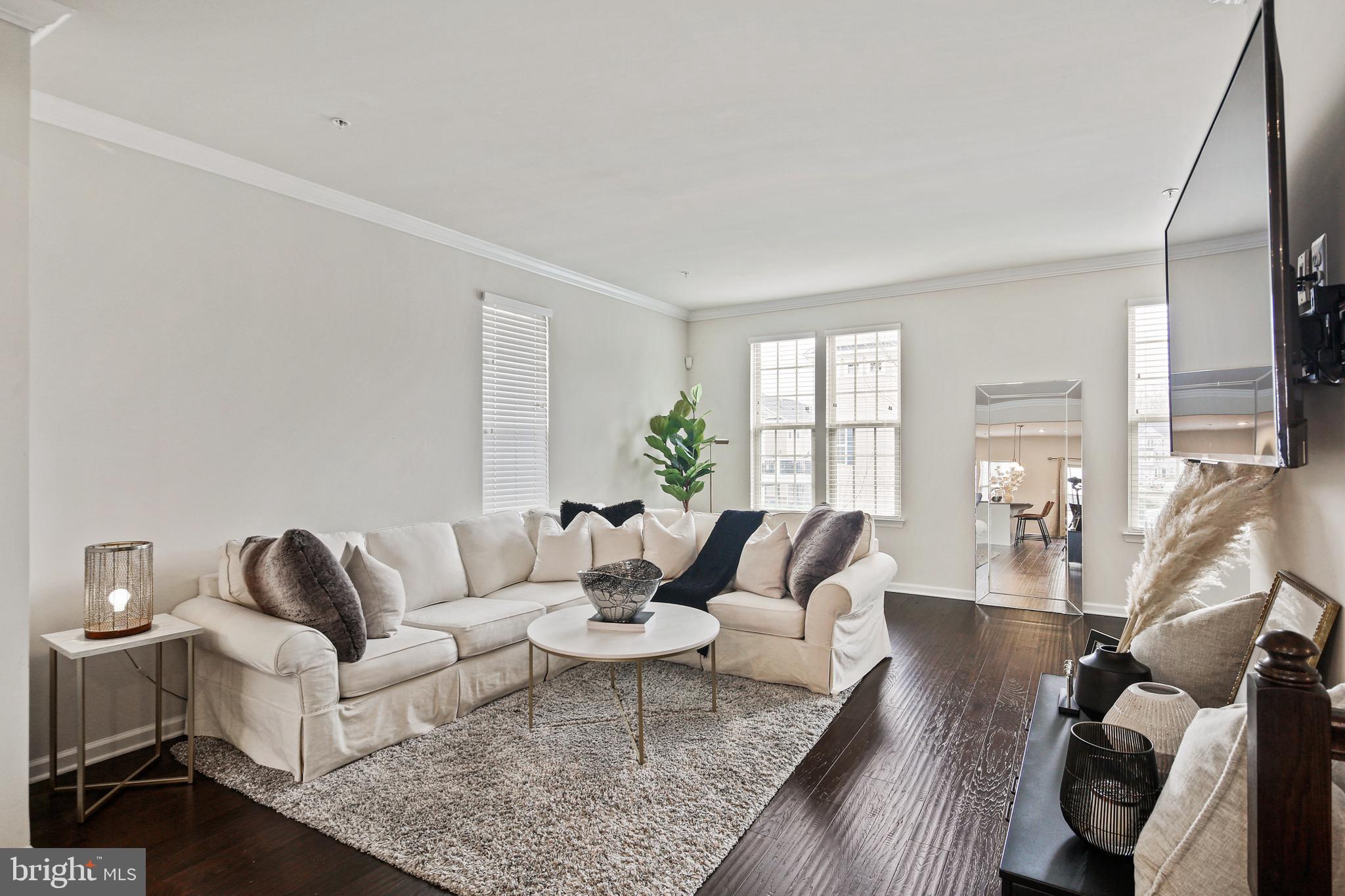 10012 Sandy Run Road Baltimore, MD 21220 - Photo 22 of 34 a living room with furniture wooden floor and a large window