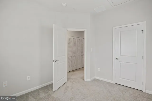 an empty room with closet area