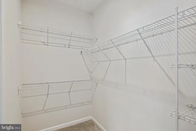 a bathroom with a granite countertop double vanity sink a mirror and a toilet