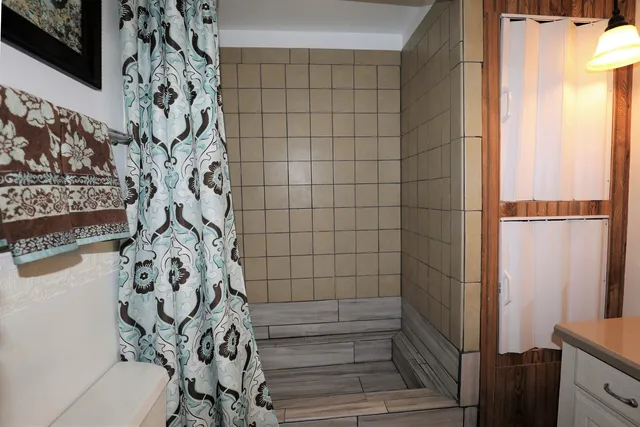 a bathroom with a bathtub and shower