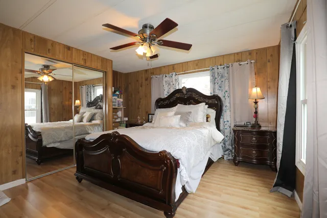 a bedroom with a bed and a chandelier