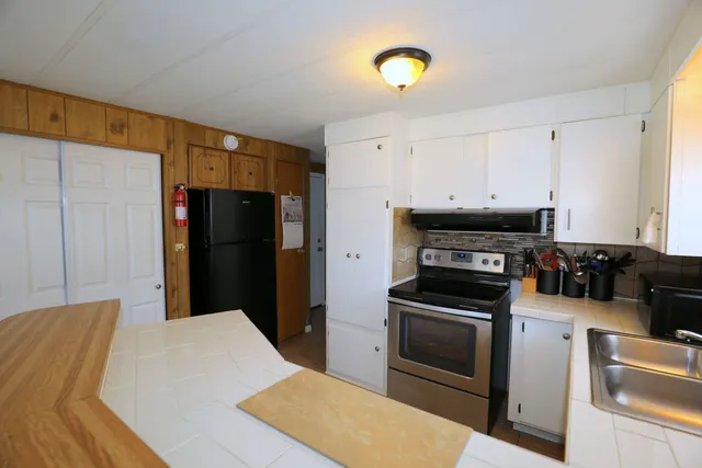 a kitchen with a refrigerator and a stove