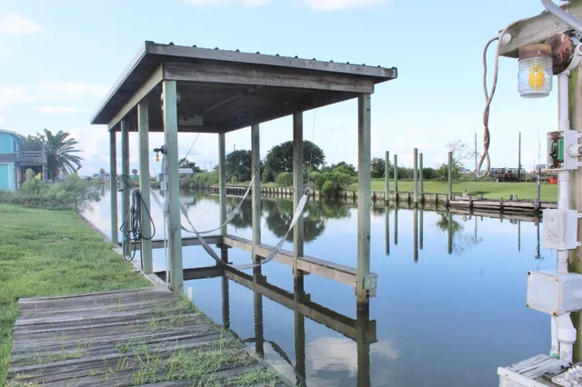 a view of a lake with a bench next to a yard