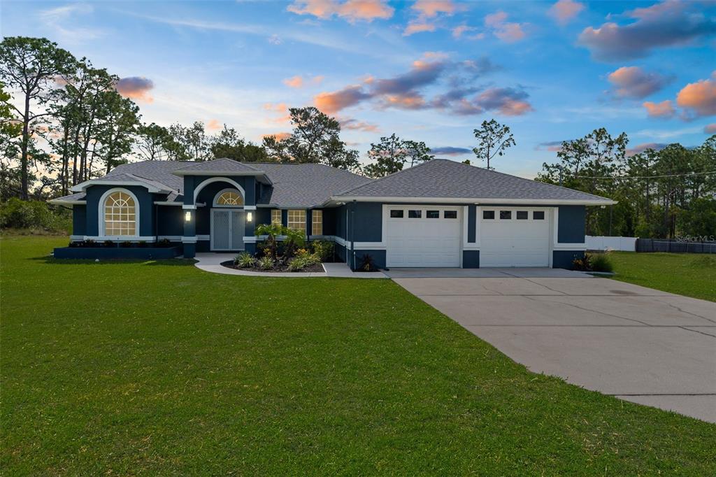 8084 Nightingale Road Weeki Wachee, FL 34613 - Photo 1 of 1 a front view of a house with garden