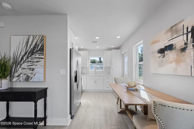 a kitchen with a refrigerator and a table