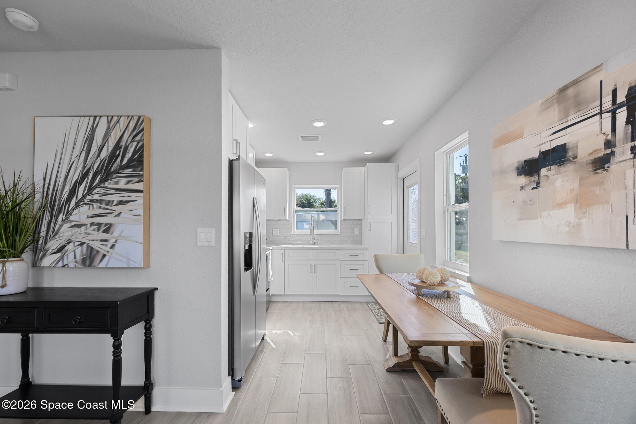 1113 Pinedale Road Rockledge, FL 32955 - Photo 5 of 19 a kitchen with a refrigerator and a table