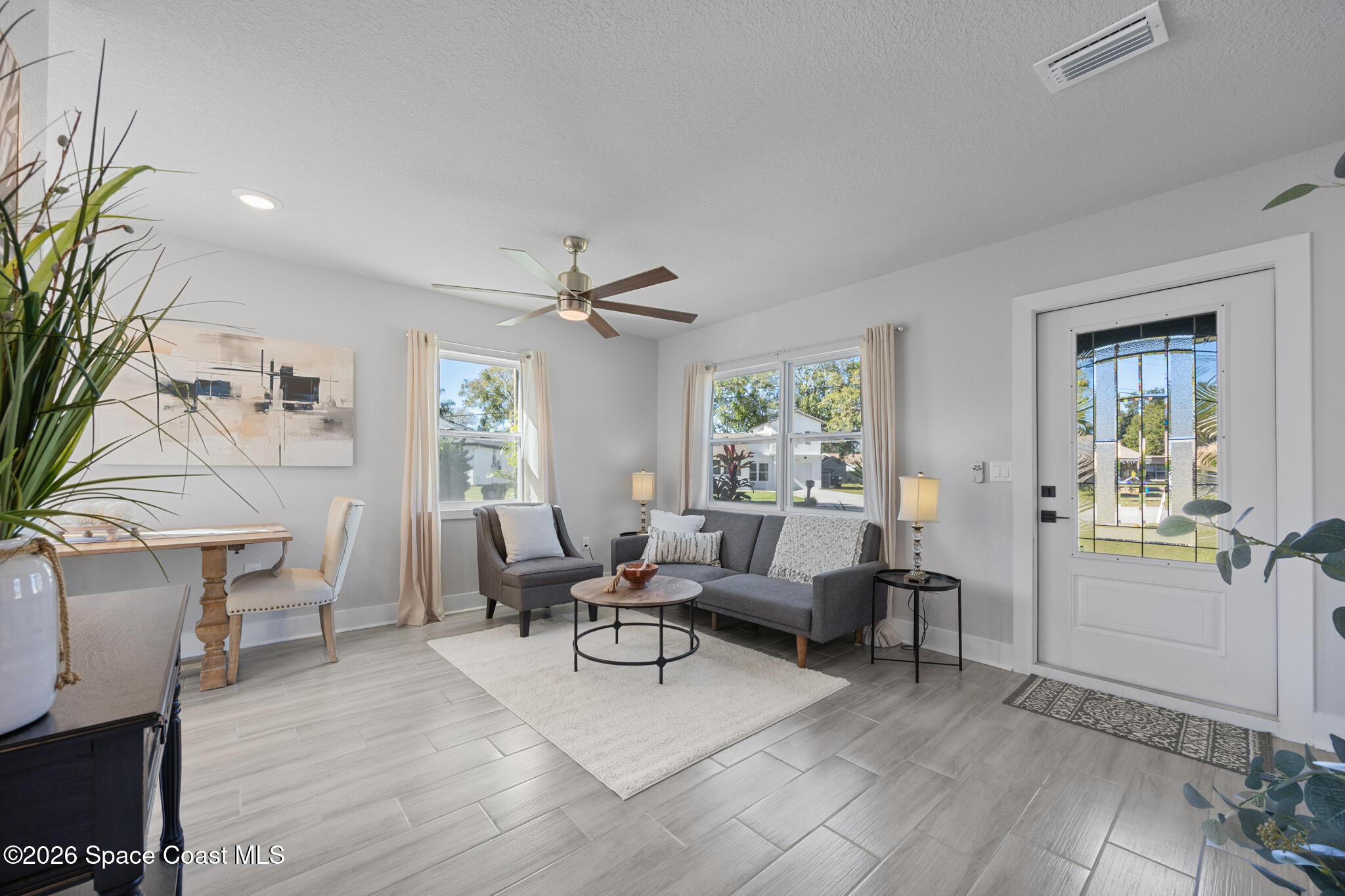 1113 Pinedale Road Rockledge, FL 32955 - Photo 7 of 19 a living room with furniture and a wooden floor