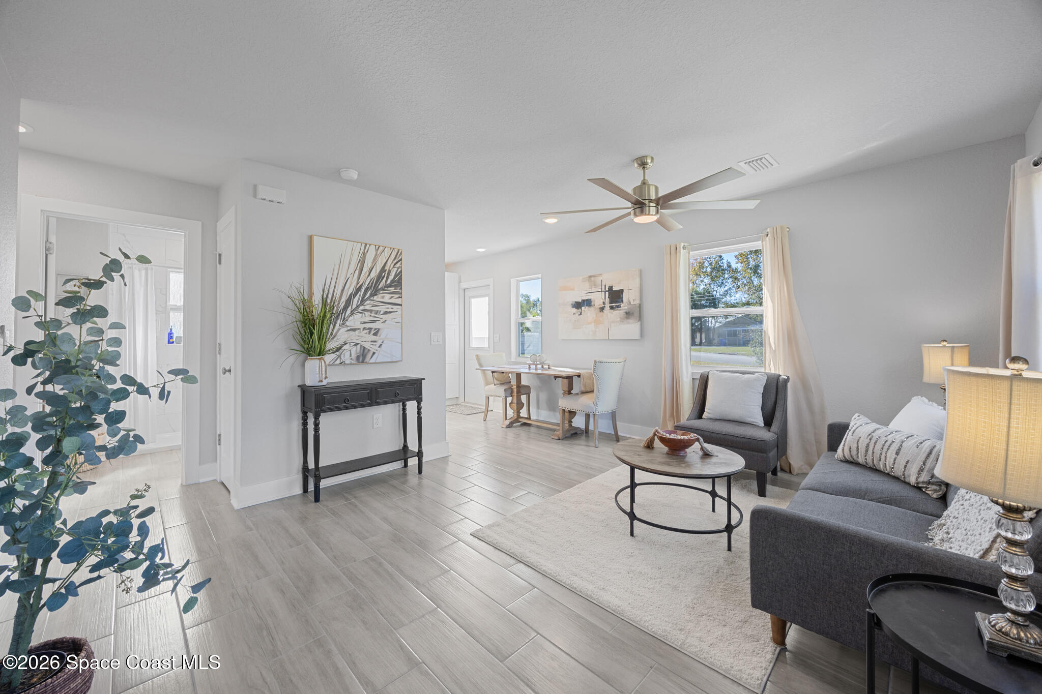 1113 Pinedale Road Rockledge, FL 32955 - Photo 8 of 19 a living room with furniture a window and a potted plant