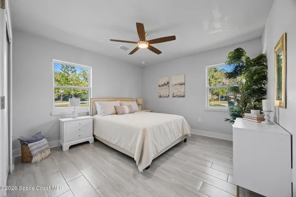 a spacious bedroom with a bed and a large window