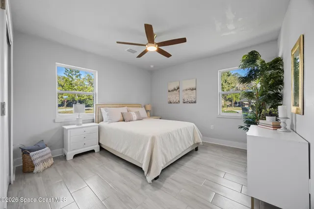 a spacious bedroom with a bed and a large window