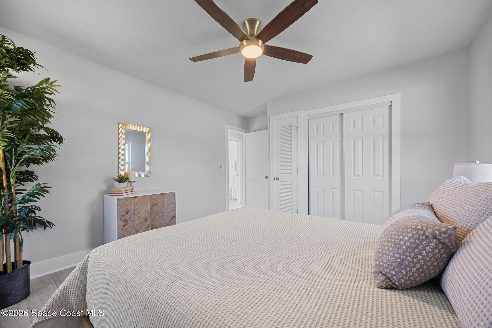 1113 Pinedale Road Rockledge, FL 32955 - Photo 10 of 19 a bedroom with a bed and a potted plant