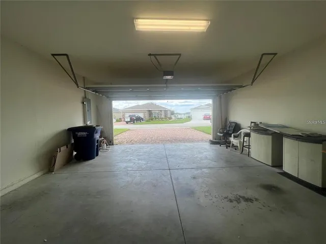 a view of a house with a big yard and palm trees