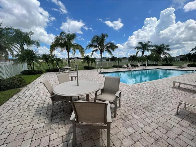 a dining room with furniture a chandelier and wooden floor