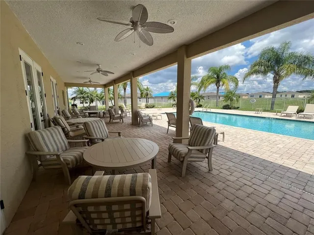 a view of a lake with table and chairs