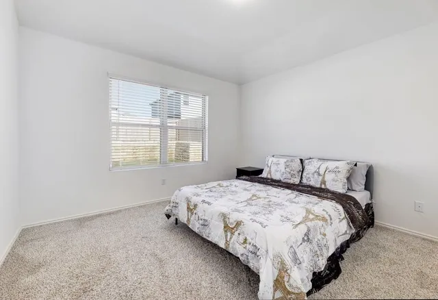 a bedroom with a bed and a window