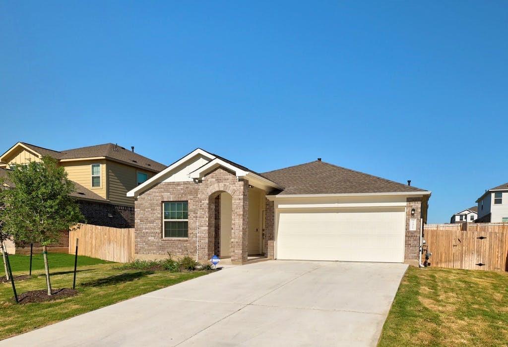 21416 Bird Wing Drive Pflugerville, TX 78660 - Photo 2 of 25 a front view of a house with a garden and yard