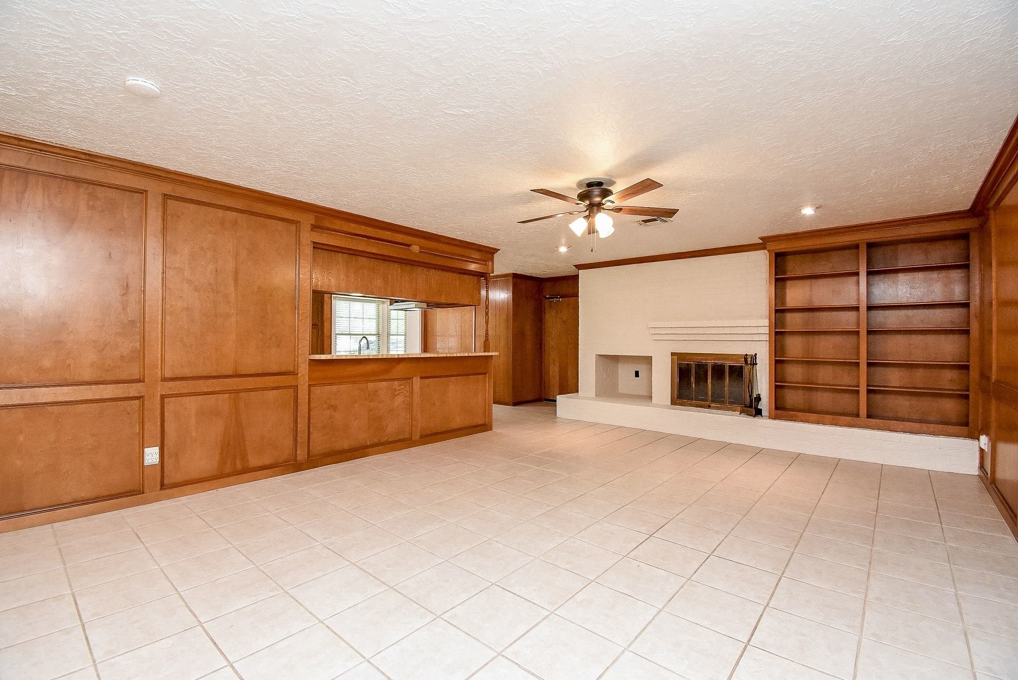 2719 Vail Road Rosenberg, TX 77471 - Photo 7 of 36 a view of an empty room with a window and fireplace