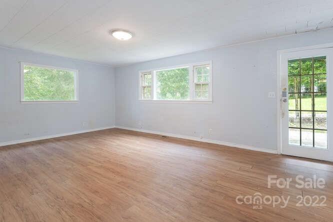 2853 Chimney Rock Road Hendersonville, NC 28792 - Photo 13 of 36 an empty room with wooden floor and windows