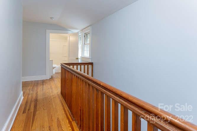 2853 Chimney Rock Road Hendersonville, NC 28792 - Photo 21 of 36 a view of a hallway with wooden floor and staircase