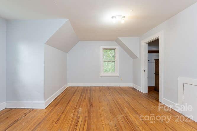 2853 Chimney Rock Road Hendersonville, NC 28792 - Photo 23 of 36 an empty room with wooden floor and windows