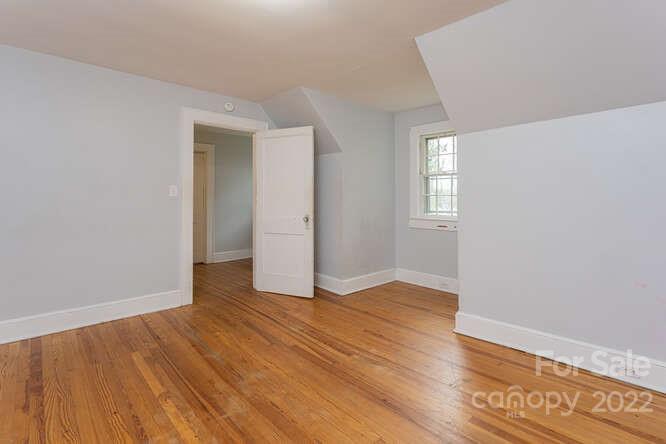 2853 Chimney Rock Road Hendersonville, NC 28792 - Photo 24 of 36 an empty room with wooden floor and windows