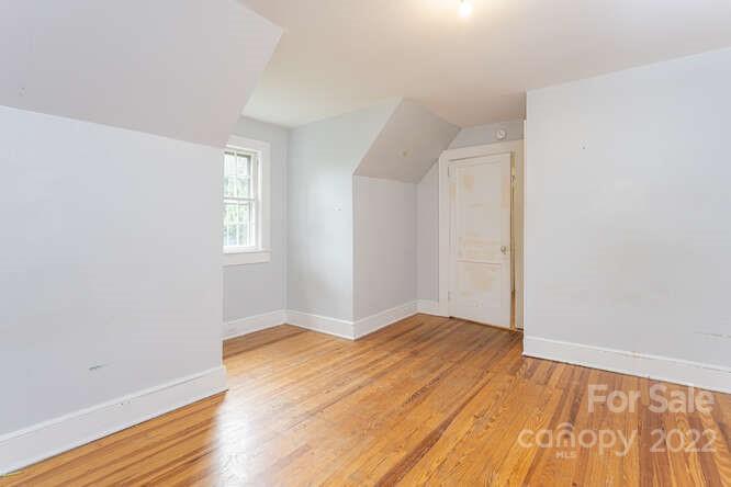 2853 Chimney Rock Road Hendersonville, NC 28792 - Photo 26 of 36 an empty room with wooden floor and windows