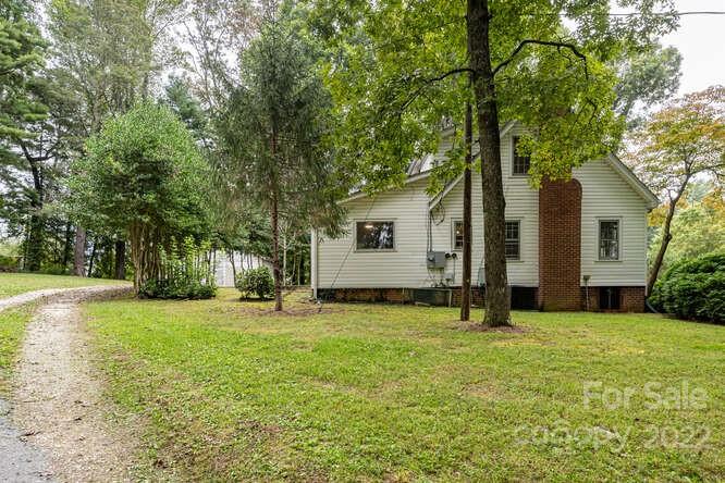 2853 Chimney Rock Road Hendersonville, NC 28792 - Photo 3 of 36 a view of a house with a yard