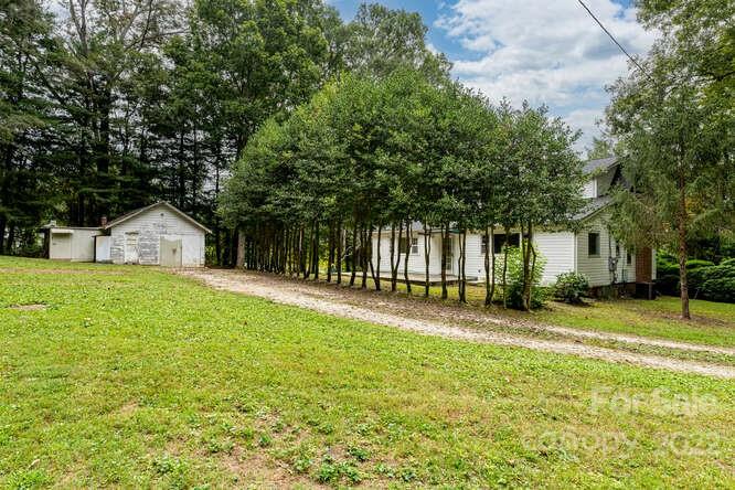 2853 Chimney Rock Road Hendersonville, NC 28792 - Photo 36 of 36 a view of a house with a yard and tree s