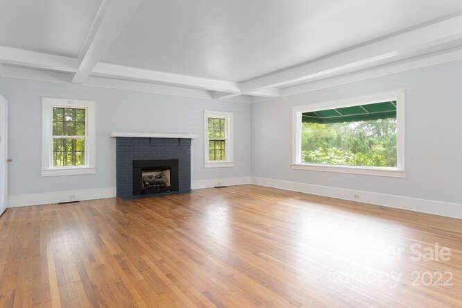 2853 Chimney Rock Road Hendersonville, NC 28792 - Photo 5 of 36 an empty room with windows and fireplace