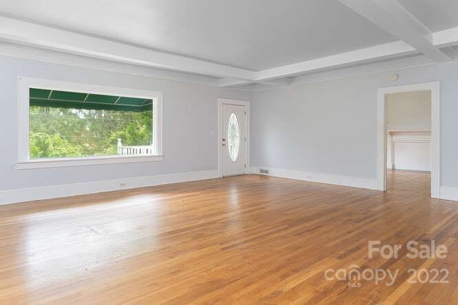 2853 Chimney Rock Road Hendersonville, NC 28792 - Photo 7 of 36 a view of an empty room with wooden floor and a window