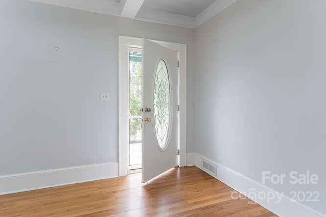2853 Chimney Rock Road Hendersonville, NC 28792 - Photo 8 of 36 an empty room with wooden floor and mirror
