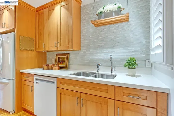 a spacious bedroom with a bed and a painting on the wall