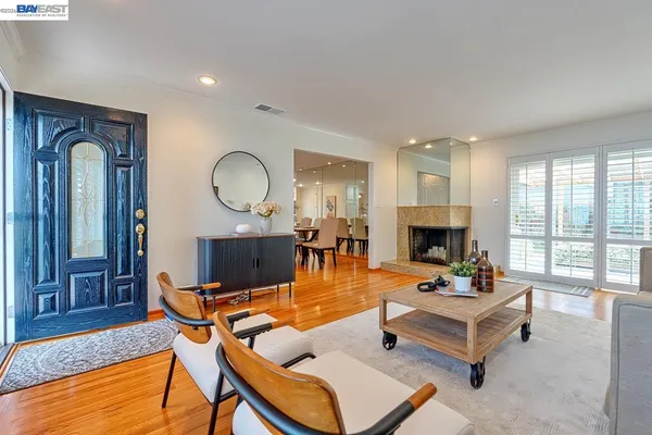 a living room with furniture fireplace and a table