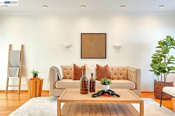 a living room with furniture and a potted plant