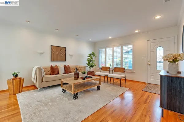 a living room with furniture a fireplace and a floor to ceiling window