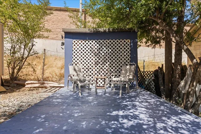 a view of a backyard with a tree